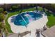Aerial view of the sparkling backyard pool with spacious patio, lush landscaping, and stylish outdoor seating at 21857 N Gibson Dr, Maricopa, AZ 85139