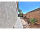 A serene side yard with drought-resistant plants and stone accents for Southwestern charm at 21857 N Gibson Dr, Maricopa, AZ 85139