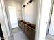 Bathroom features wooden cabinet without countertop and modern lighting fixture, waiting to be finished at 22961 E Twin Acres Dr, Queen Creek, AZ 85142