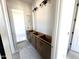 Bathroom with a new vanity featuring dark wood cabinets with brushed nickel hardware and modern lighting at 22961 E Twin Acres Dr, Queen Creek, AZ 85142
