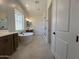 Elegant bathroom featuring double vanities, a soaking tub, and a glass enclosed shower at 22961 E Twin Acres Dr, Queen Creek, AZ 85142