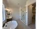 Modern bathroom with sleek glass shower, stylish fixtures, and ample natural light at 22961 E Twin Acres Dr, Queen Creek, AZ 85142