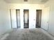 Bright bedroom with multiple doorways and closet, ready for customization with neutral walls and flooring at 22961 E Twin Acres Dr, Queen Creek, AZ 85142