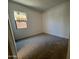 Comfortable bedroom with neutral carpet, a bright window, and neutral decor at 22961 E Twin Acres Dr, Queen Creek, AZ 85142