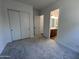 Cozy bedroom featuring carpet flooring, closet, and access to an ensuite bathroom at 22961 E Twin Acres Dr, Queen Creek, AZ 85142