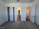 Bright bedroom featuring a closet and multiple doors, including access to the hallway at 22961 E Twin Acres Dr, Queen Creek, AZ 85142