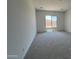 Spacious bedroom featuring plush carpet and large window offering ample natural light at 22961 E Twin Acres Dr, Queen Creek, AZ 85142