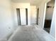 Bright bedroom with closet and open doorway, ready for customization with neutral walls and flooring at 22961 E Twin Acres Dr, Queen Creek, AZ 85142