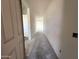 Bright entryway featuring a long hallway with white walls, leading to a well-lit area at the end at 22961 E Twin Acres Dr, Queen Creek, AZ 85142