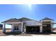 Unfinished exterior of a home with a two-car garage under construction on a sunny day at 22961 E Twin Acres Dr, Queen Creek, AZ 85142
