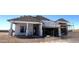 Under-construction view of a home with a two-car garage and a covered porch framed by columns at 22961 E Twin Acres Dr, Queen Creek, AZ 85142