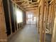 Unfinished room showing wood framing, with plumbing and electrical, offering future customization at 22961 E Twin Acres Dr, Queen Creek, AZ 85142
