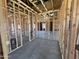 An unfinished interior with exposed wood framing, showcasing construction elements with concrete floor at 22961 E Twin Acres Dr, Queen Creek, AZ 85142