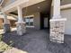 Inviting front porch with stone-accented columns and pavers for a touch of elegant curb appeal at 22961 E Twin Acres Dr, Queen Creek, AZ 85142