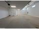 Spacious garage with ample room for parking and storage and door to the house at 22961 E Twin Acres Dr, Queen Creek, AZ 85142