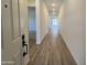 Bright hallway featuring sleek wood-look flooring, recessed lighting, and contemporary design at 22961 E Twin Acres Dr, Queen Creek, AZ 85142
