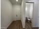 Hallway with wood-look tile floor leads to the powder room at 22961 E Twin Acres Dr, Queen Creek, AZ 85142