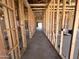 Unfinished hallway showing framed walls and open studs; plumbing and electrical wiring are visible at 22961 E Twin Acres Dr, Queen Creek, AZ 85142