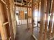 Unfinished interior framing showcases exposed studs, wiring, and structural elements of the new home at 22961 E Twin Acres Dr, Queen Creek, AZ 85142