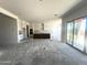 Bright kitchen featuring white cabinets, a large island, and sliding glass doors to the backyard at 22961 E Twin Acres Dr, Queen Creek, AZ 85142