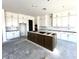 Beautiful kitchen features an island, white cabinets and modern design at 22961 E Twin Acres Dr, Queen Creek, AZ 85142