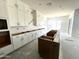 Modern kitchen with white cabinets, a large island, and plenty of natural light at 22961 E Twin Acres Dr, Queen Creek, AZ 85142
