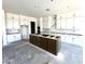 Spacious kitchen featuring white cabinets, a large island, and modern design elements at 22961 E Twin Acres Dr, Queen Creek, AZ 85142