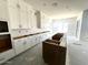 Gorgeous kitchen features an island, white cabinets, modern design, and lots of natural light at 22961 E Twin Acres Dr, Queen Creek, AZ 85142