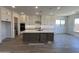 Gourmet kitchen with white cabinets, large island with seating, and stainless steel appliances at 22961 E Twin Acres Dr, Queen Creek, AZ 85142