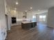 Large kitchen with white cabinets, stainless steel appliances, and a dark wood island at 22961 E Twin Acres Dr, Queen Creek, AZ 85142