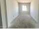 Bright living room offering space for customization with concrete floors, neutral walls, and a window for natural light at 22961 E Twin Acres Dr, Queen Creek, AZ 85142