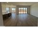 Open-concept kitchen and living room with wood tile flooring and sliding glass doors to backyard at 22961 E Twin Acres Dr, Queen Creek, AZ 85142