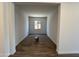 A living room with wood-look tile floor, light walls, and a window at 22961 E Twin Acres Dr, Queen Creek, AZ 85142