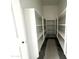 Spacious walk-in pantry featuring white shelving units and ample storage space at 22961 E Twin Acres Dr, Queen Creek, AZ 85142