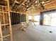 View of an unfinished space with wood framing, smooth concrete floors, and sliding glass doors at 22961 E Twin Acres Dr, Queen Creek, AZ 85142