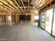 Bright unfinished room with wood framing, concrete floors, and access to the backyard via sliding doors at 22961 E Twin Acres Dr, Queen Creek, AZ 85142