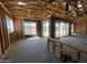 Unfinished room showing wood framing and large sliding glass doors for natural light at 22961 E Twin Acres Dr, Queen Creek, AZ 85142