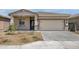 Charming single-story home featuring a spacious two-car garage and well-maintained landscaping at 24577 W St Anne Ave, Buckeye, AZ 85326