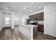 Modern kitchen features stainless steel appliances, granite countertops, and a central island at 24577 W St Anne Ave, Buckeye, AZ 85326