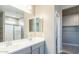 Bathroom featuring dual sink vanity and glass shower door at 2480 S 241St Ave, Buckeye, AZ 85326