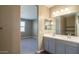 Bathroom featuring double sink vanity and open view into bedroom at 2480 S 241St Ave, Buckeye, AZ 85326