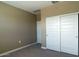 Cozy bedroom features a closet and an interior door, and carpet flooring at 2480 S 241St Ave, Buckeye, AZ 85326