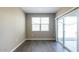 Bedroom with wood-look tile, sliding glass doors to patio and neutral decor at 2480 S 241St Ave, Buckeye, AZ 85326