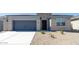 Charming single-story home featuring a two-car garage and low-maintenance desert landscaping at 2480 S 241St Ave, Buckeye, AZ 85326