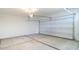 Spacious garage with concrete floor, garage door, and overhead lighting at 2480 S 241St Ave, Buckeye, AZ 85326