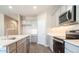 Stylish kitchen with stainless steel appliances, light gray cabinets, and sleek quartz countertops at 2480 S 241St Ave, Buckeye, AZ 85326