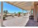 Inviting covered back patio featuring pavers, pergola, and view of the golf course and desert landscaping at 2643 E San Ricardo Trl, Casa Grande, AZ 85194