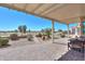 Relax on the covered back patio overlooking the meticulously maintained backyard and distant mountains at 2643 E San Ricardo Trl, Casa Grande, AZ 85194