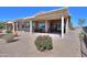 A covered back patio with chairs and a table is situated in front of a desert landscape at 2643 E San Ricardo Trl, Casa Grande, AZ 85194