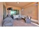 Enjoy outdoor living on this cozy covered patio with comfortable seating and grill at 2643 E San Ricardo Trl, Casa Grande, AZ 85194